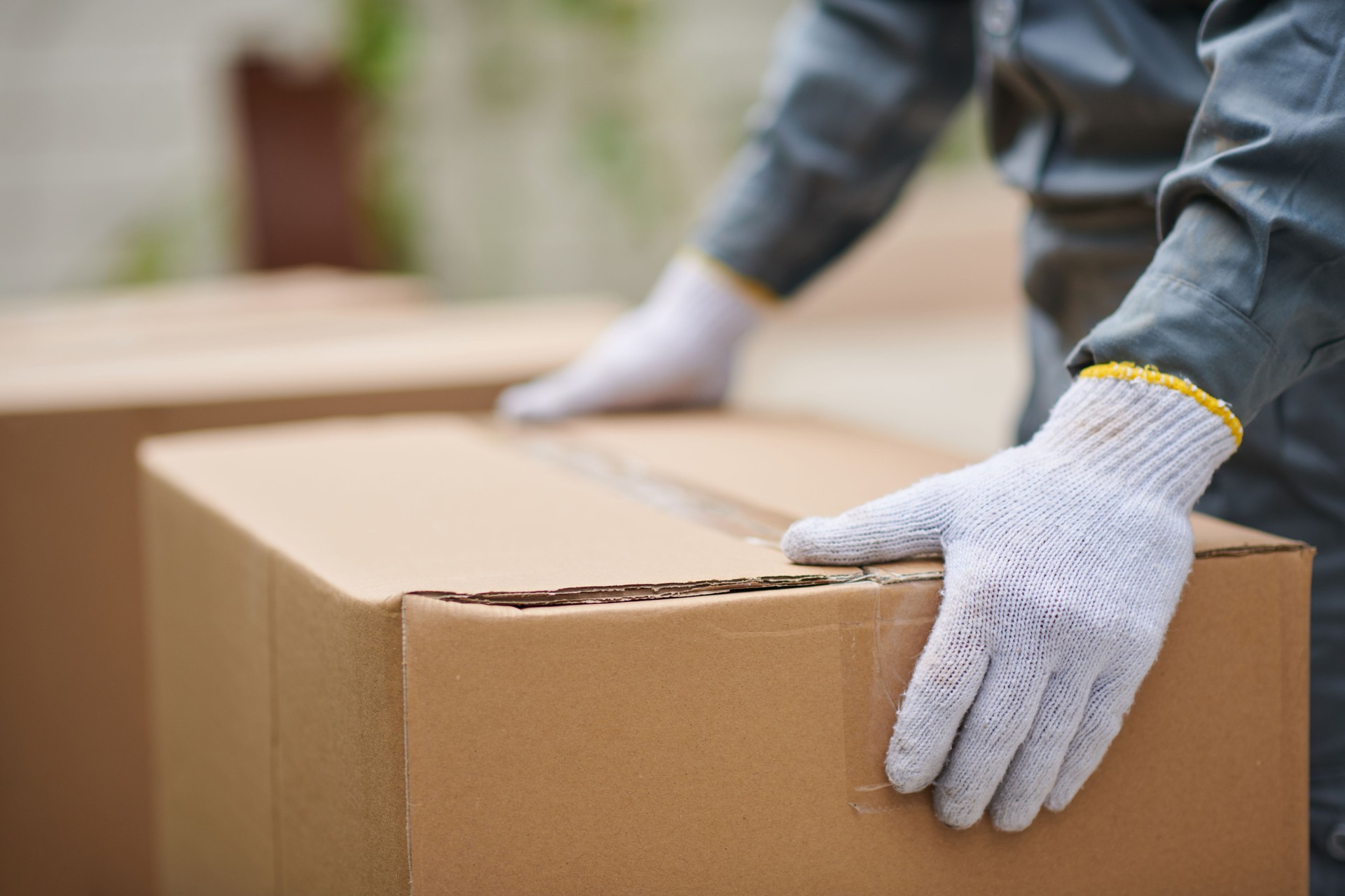 Mover Carrying Cardboard Boxes